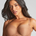 Une personne aux cheveux longs et noirs portant un soutien-gorge beige. Mode Grande taille