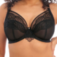 Une personne portant le soutien-gorge en dentelle noire "Soutien gorge plunge Priya noir" avec des motifs décoratifs, présenté de la taille vers le haut. Mode Grande taille