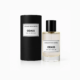 Un flacon de Parfum Odass Collection Privée à côté de son emballage cylindrique noir assorti. Mode Grande taille