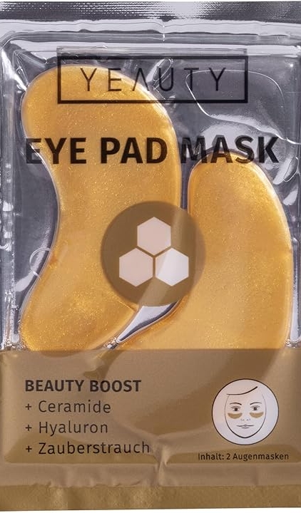 Des masques dorés pour le contour des yeux dans un emballage transparent et doré portant la mention "Masque lissant pour les yeux" pour une mise en beauté. Mode Grande taille