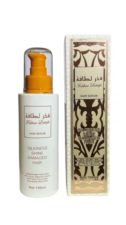 Un flacon et une boîte de Sérum cheveux parfumé - Fakhar Lattafa, présentant un design doré et blanc et étiqueté pour des cheveux soyeux, brillants et abîmés. Mode Grande taille