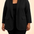 Une femme portant le Blazer ouvert en noir sur un fond clair uni. Mode Grande taille