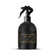 Flacon pulvérisateur noir étiqueté "MONOÏ Gris Montaigne Paris" avec une étiquette rehaussée d'or sur fond blanc. Mode Grande taille