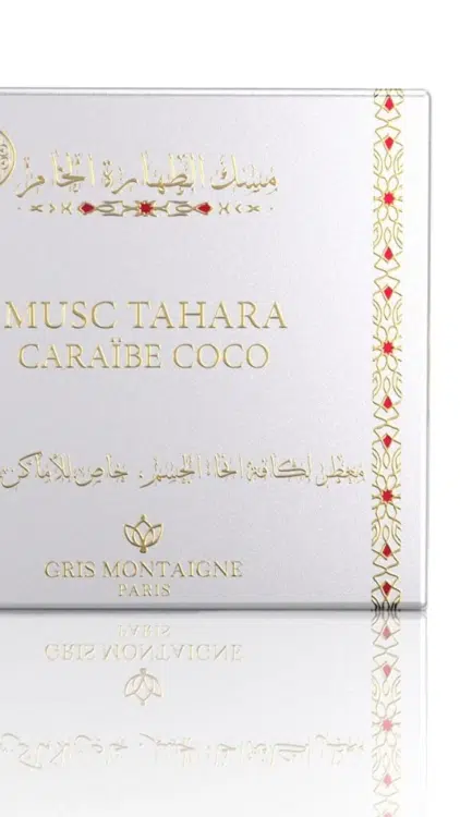 Un flacon de parfum Musc Tahara Caraïbes Coco Gris Montaigne présenté à côté de sa boîte blanche décorative. Mode Grande taille