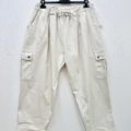 Pantalon cargo en coton super stretch, beige, présenté sur un cintre noir contre un mur blanc. Mode Grande taille
