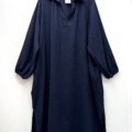 Robe col chemise fendue sur les côtés, bleu marine, à manches longues et col, suspendue à un cintre noir contre un mur blanc. Mode Grande taille