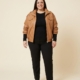 Veste en simili cuir camel à col montant, grande taille, portée ouverte par une femme taille 54
